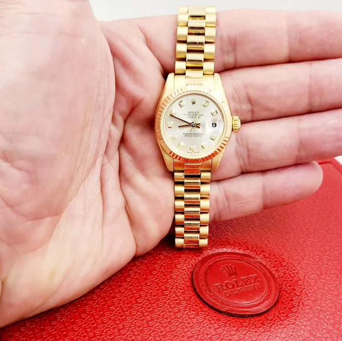 Ladies Rolex 26mm Presidential 18K Yellow Gold Watch with Silver Diamond Dial and Fluted Bezel PreOwned Rolex PreStyled Sets
